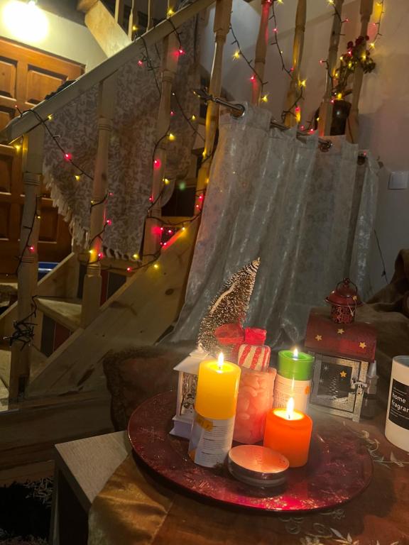 a table with candles and a hammock with lights at Μεζονέτα στους Αγίους Δέκα Κέρκυρας in Áyioi Dhéka