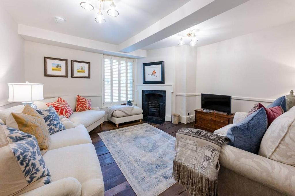 a living room with two couches and a fireplace at Pass the Keys Juno Apartment In the centre of historic Ludlow in Ludlow