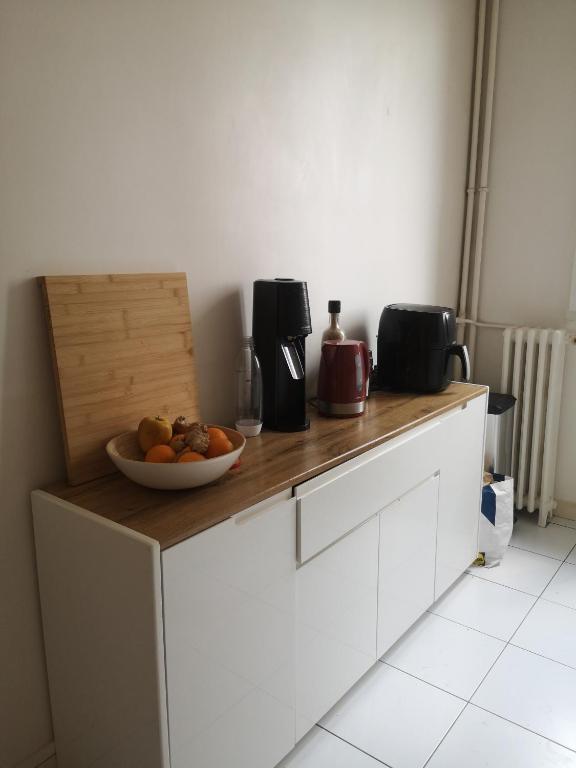une cuisine avec un bol de fruits sur un comptoir dans l'établissement Maud’s apppartment, à Asnières-sur-Seine