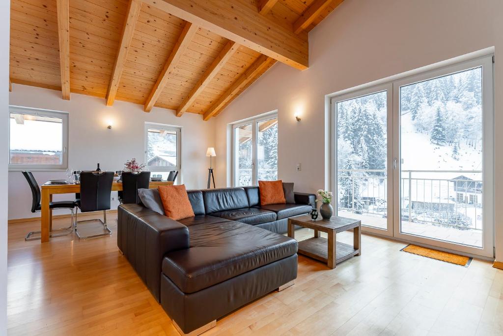 a living room with a couch and a table at Schmittenhöhe Lodge in Zell am See