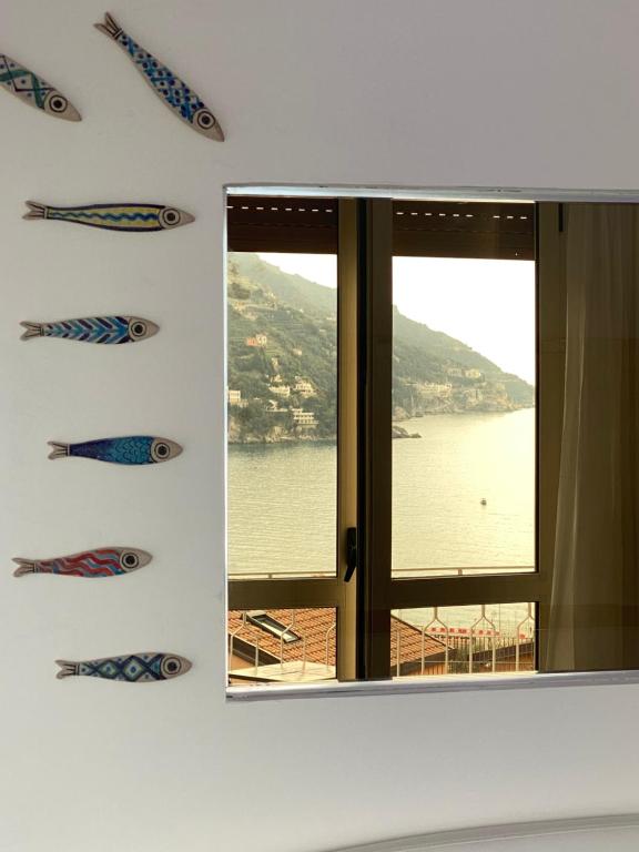 a room with a window with kites on the wall at Hotel Vietri Coast in Vietri sul Mare