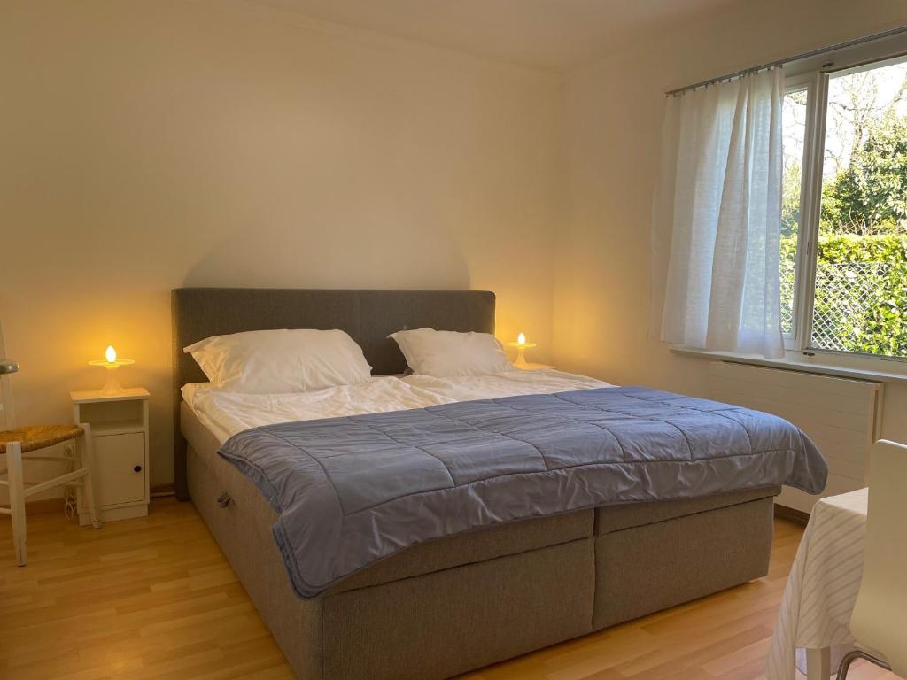 a bedroom with a large bed with two candles on it at Appartamento Via Saleggi 10 in Ascona