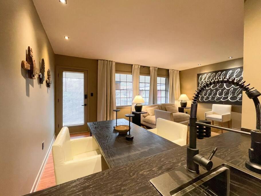 a kitchen and living room with a couch and a table at Luxury Warehouse District Condo in Durham