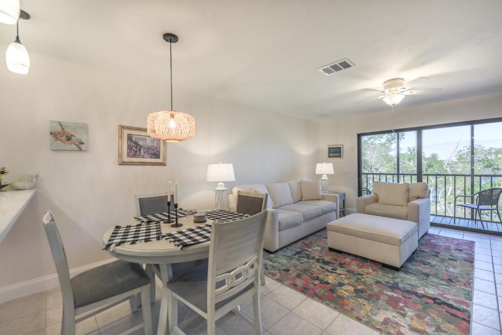 a dining room and living room with a table and chairs at LAKE PALMS 1 in Sanibel