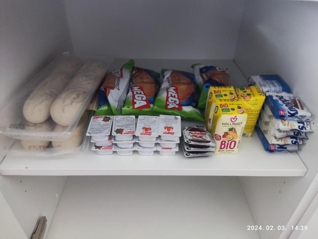 a shelf in a refrigerator filled with different types of food at Apartment Feldkirch in Feldkirch