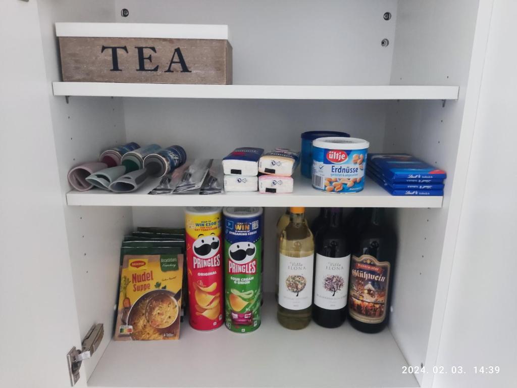 a cupboard filled with lots of food and drinks at Apartment Feldkirch in Feldkirch