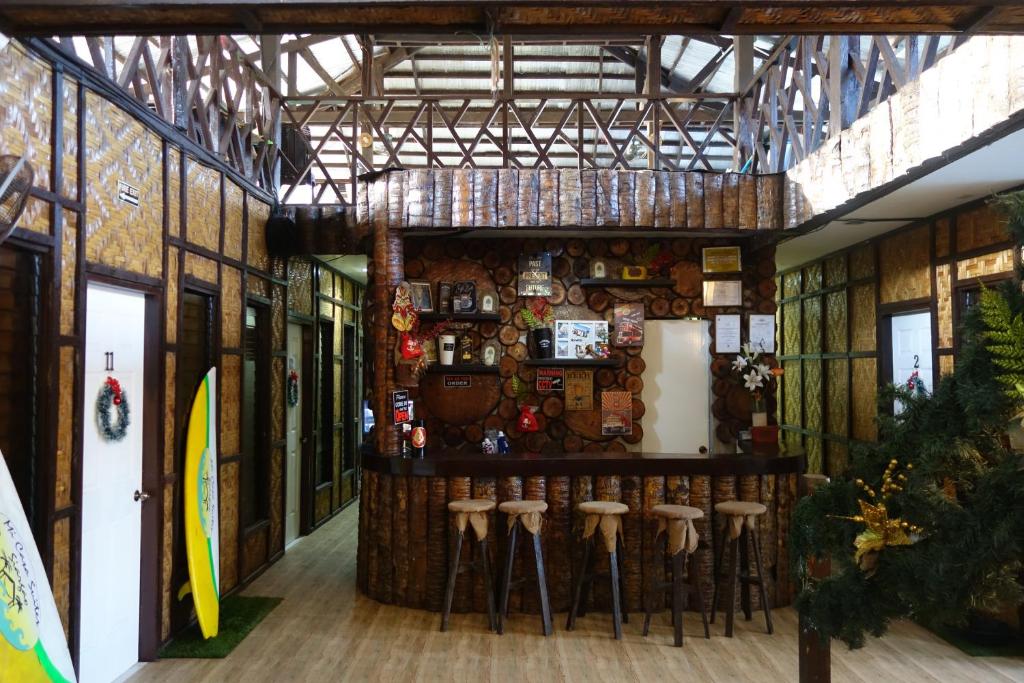 a room with a bar with stools on the wall at Mi Casa Suites Siargao in General Luna