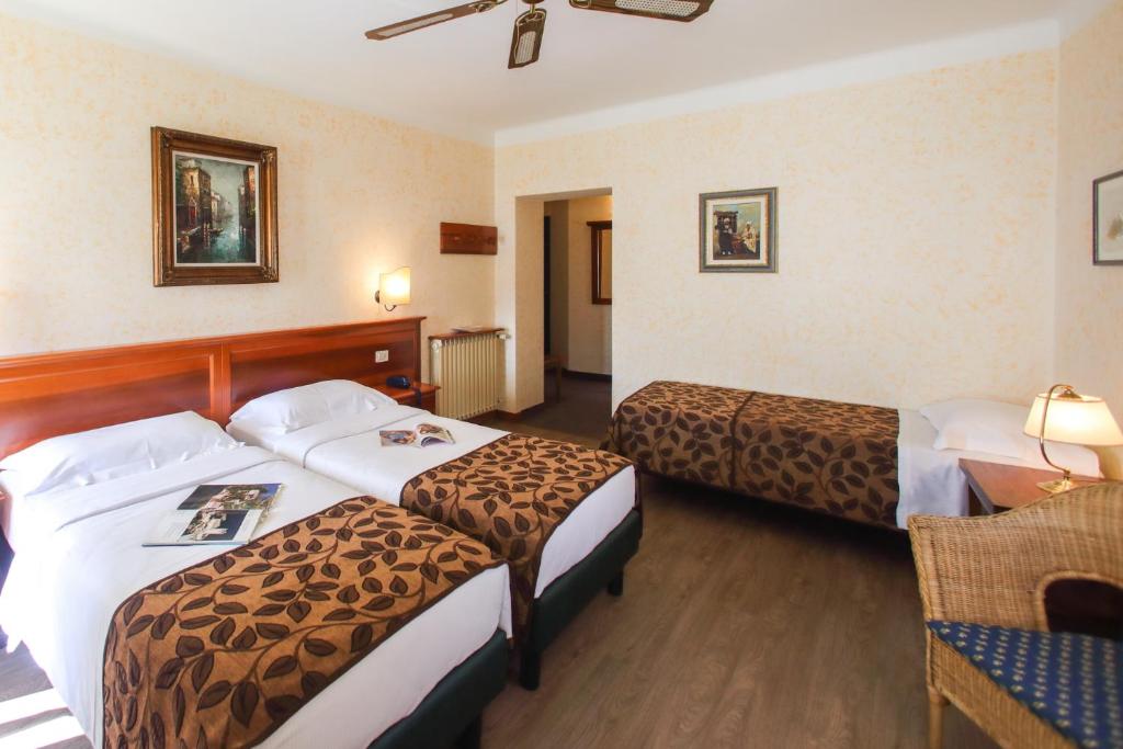Postel nebo postele na pokoji v ubytování Hotel Garnì Riviera