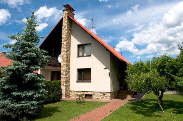 a white house with a red roof and a tree at Ubytování v apartmánech pod Radhoštěm in Prostřední Bečva