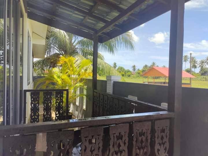 a balcony with a view of a house at Langkawi Homestay Bunga Padi in Kuah