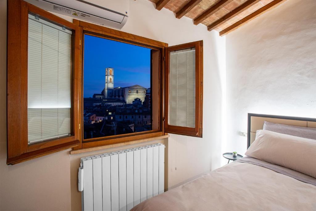 um quarto com uma janela com vista para um edifício em Panoramic Apartment - A due passi dal centro - Vicino alla Mini Metro Pincetto em Perugia