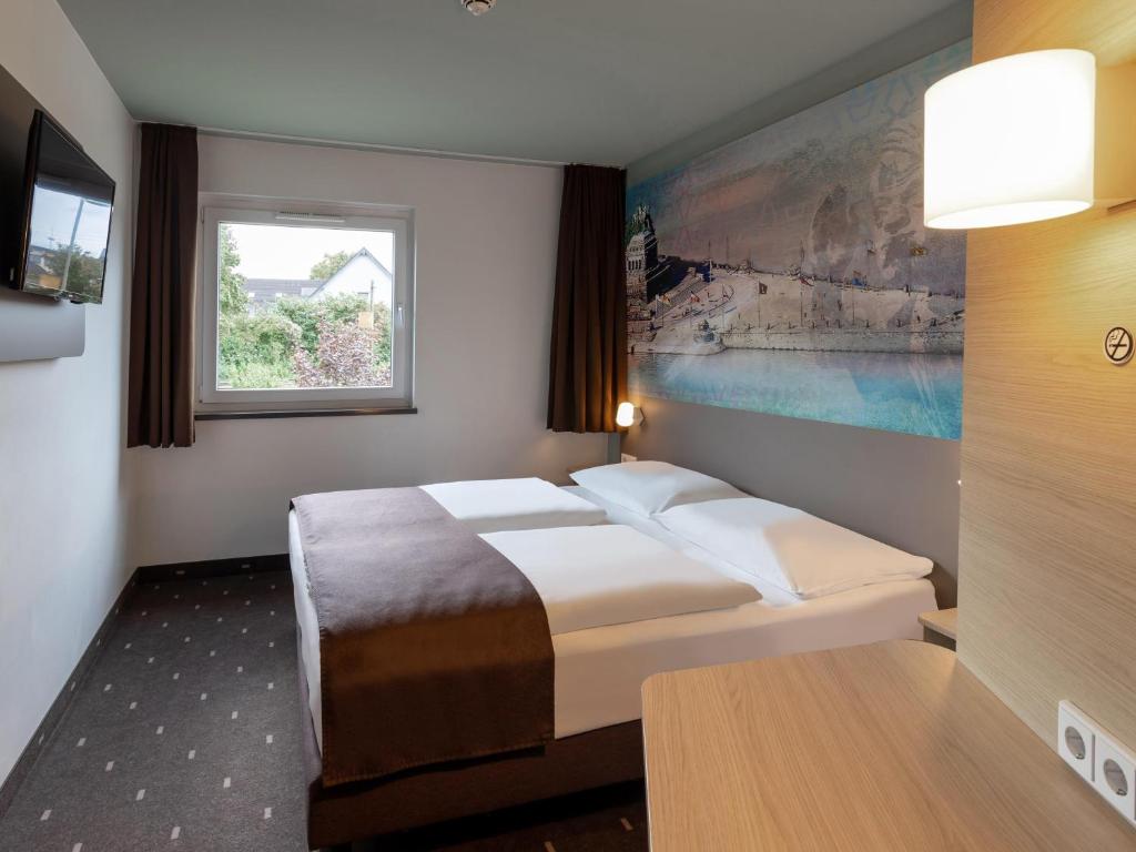 Postel nebo postele na pokoji v ubytování B&B Hotel Koblenz-City