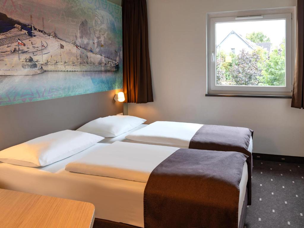 Postel nebo postele na pokoji v ubytování B&B Hotel Koblenz-City