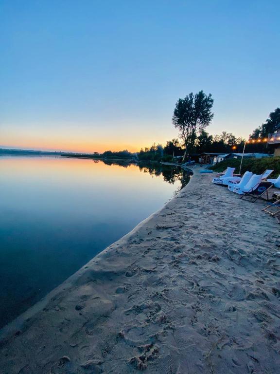 a beach with lounge chairs and the water at Małe Morze in Chałupy