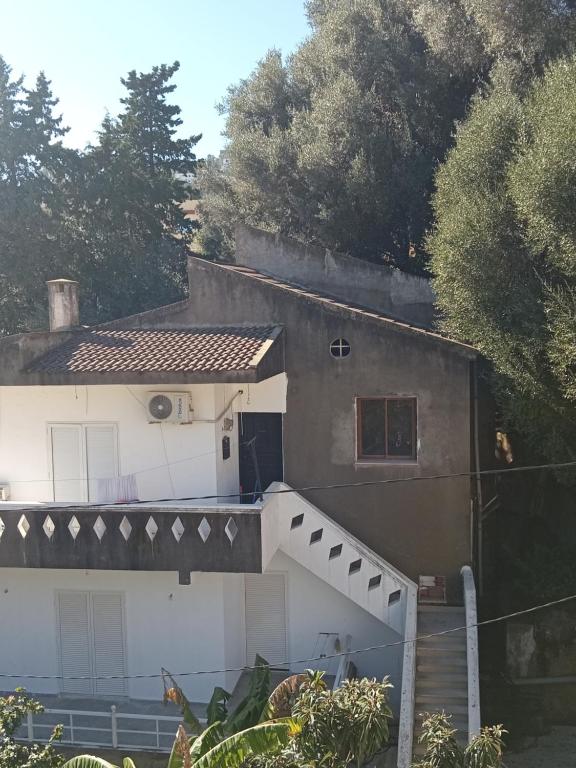 a house with a staircase leading up to it at Maison de vacances in Tabarka