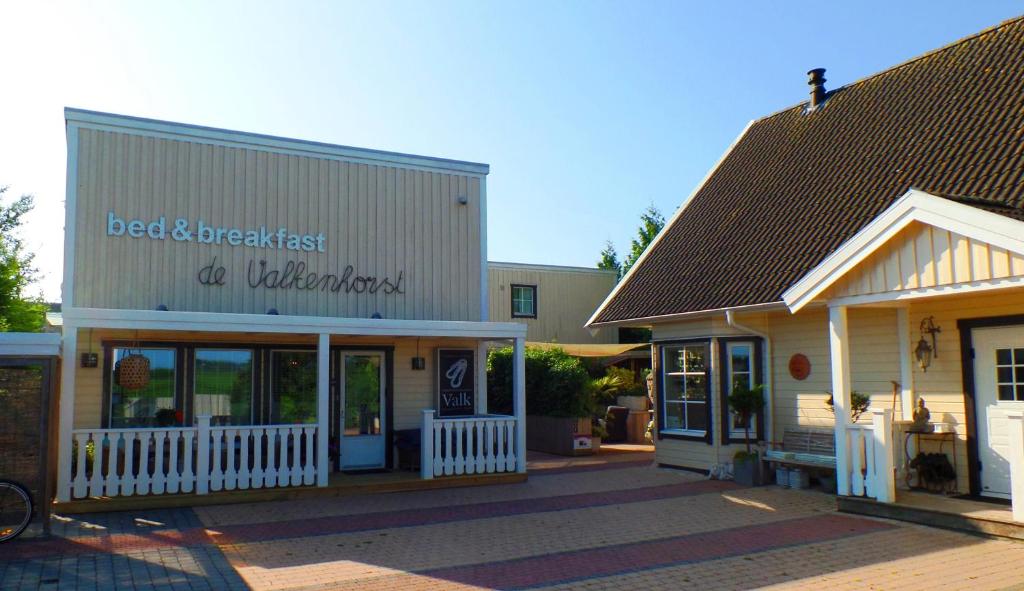 a building with a sign that reads bed breakfast a wilderness at B&B de Valkenhorst in Lelystad