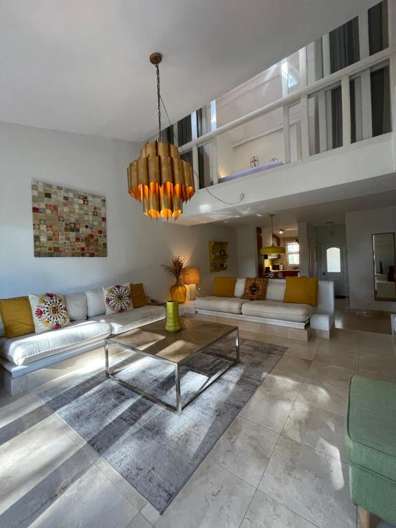 a living room with couches and a coffee table at Private Villa in Quinta da Marinha with golf view! in Cascais