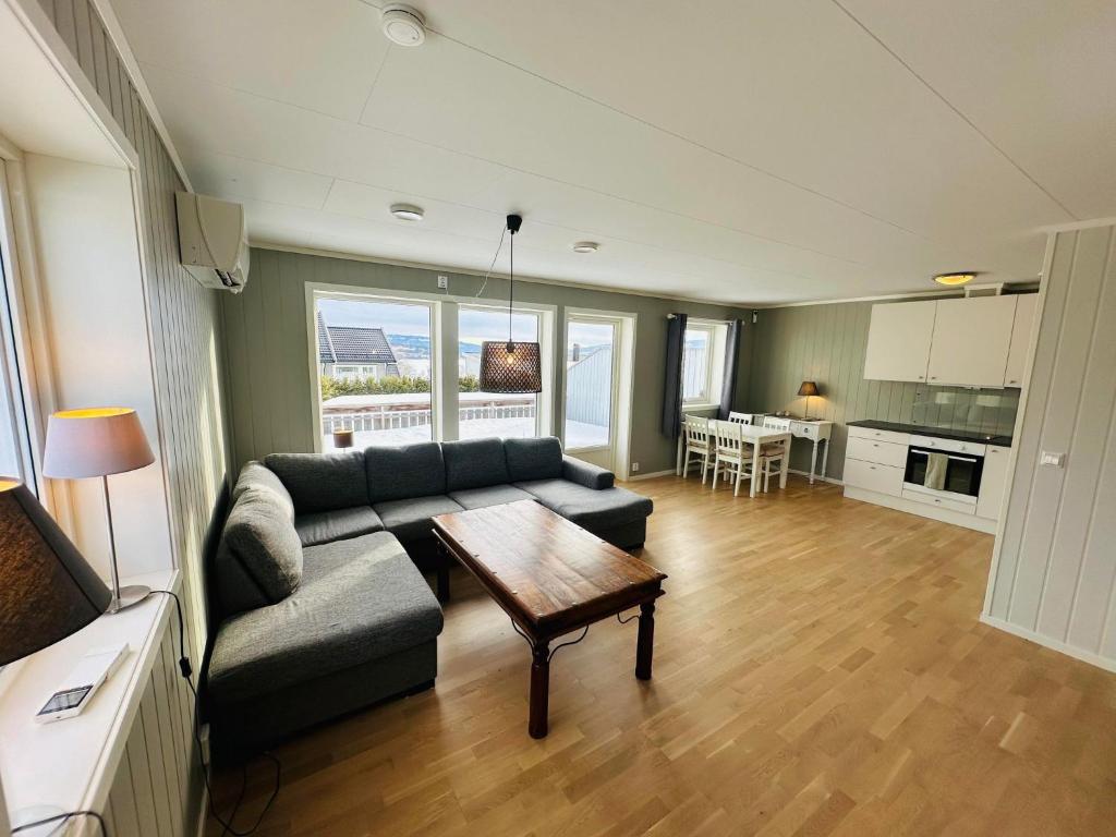 a living room with a couch and a table at Nydelig perle ved Tyrifjorden 