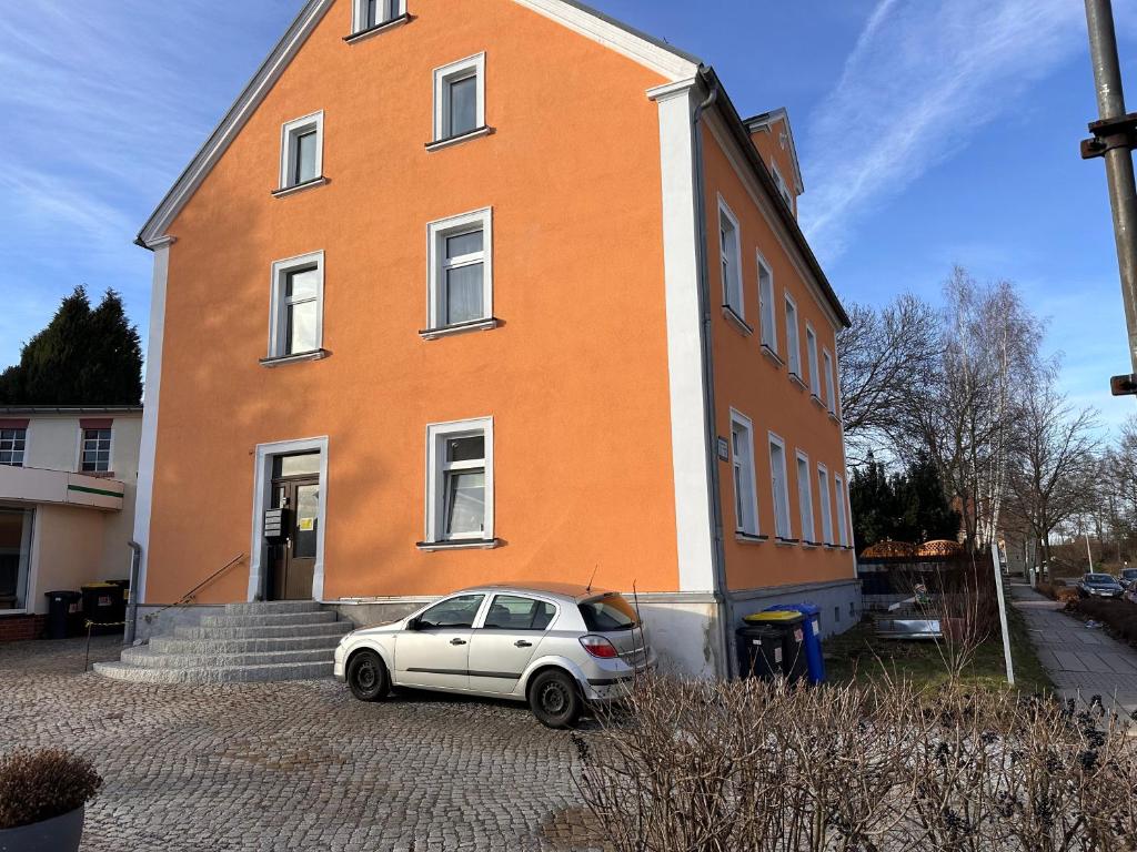 a white car parked in front of a building at FeWo BiBo in Freiberg