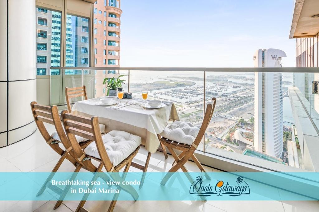 a dining room with a table and chairs on a balcony at Breathtaking sea-view condo in Dubai Marina - Palm Views! in Dubai