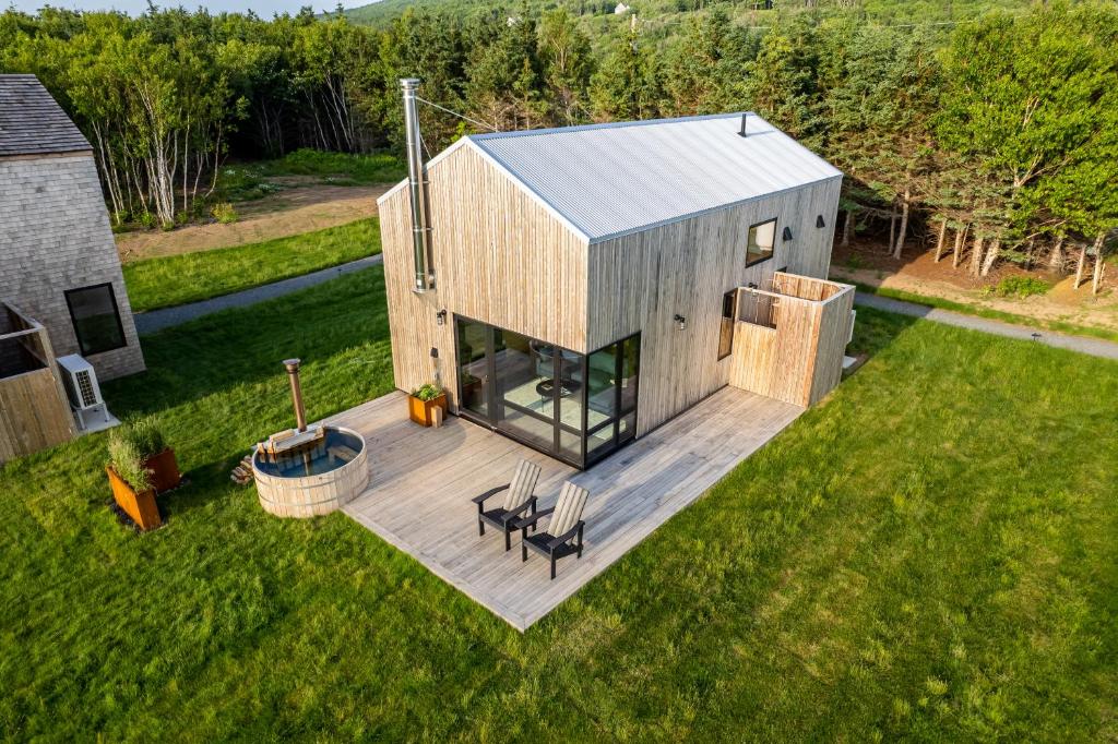 an overhead view of a house with a deck at Spruce - Luxury 1 Bdrm Cottage Stunning Views & Hot Tub, Private Path to the Beach in Margaree Harbour