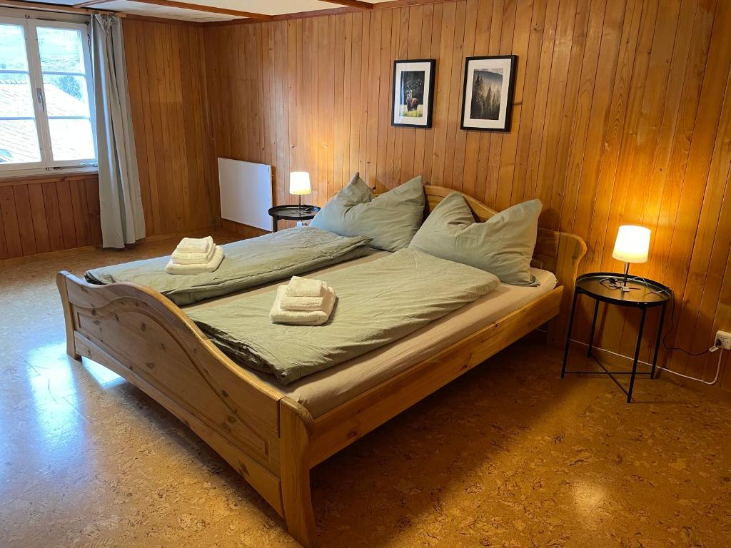 a bedroom with a large bed with two towels on it at Gemütliche Wohnung mit traditionellem Trittofen in Innertkirchen