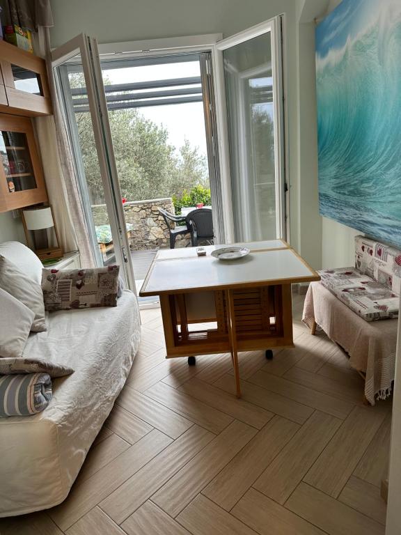 a room with a bed and a table and a window at Casa del sasso in Bergeggi