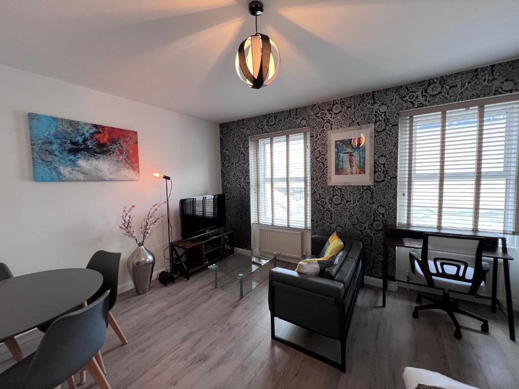 a living room with a table and chairs at Flat in central London with large patio in London