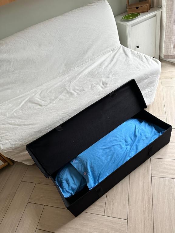 a bed with a box on the floor at Casa del sasso in Bergeggi