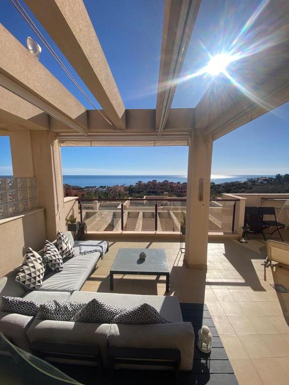 a patio with couches and a table on a building at Amazing Sea View! in Isla Plana