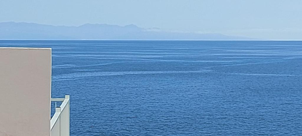 a view of the ocean from a building at LAS OLAS ATICO PENHOUSE with TERRACE and SEA VIEW in La Caleta