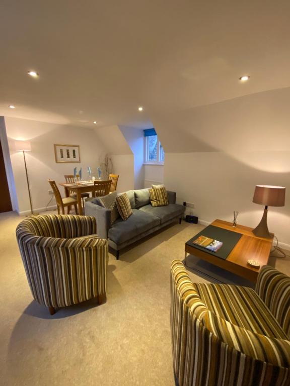 a living room with two couches and a table at Bellfosters in King's Lynn