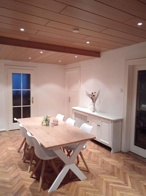 a dining room with a wooden table and chairs at Ferienwohnung Allgäu 2 in Memmingen