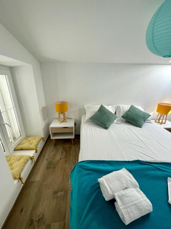 a bedroom with two beds with towels on them at Duplex en plein centre in Propriano