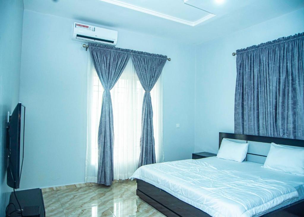 a bedroom with a bed and a window with curtains at Cis service apartment in Ketti