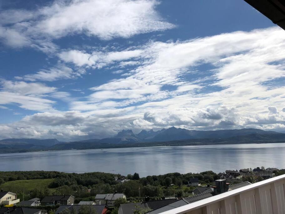 a view of a large body of water with mountains at Panorama view! Modern,Balcony/parking in Bodø