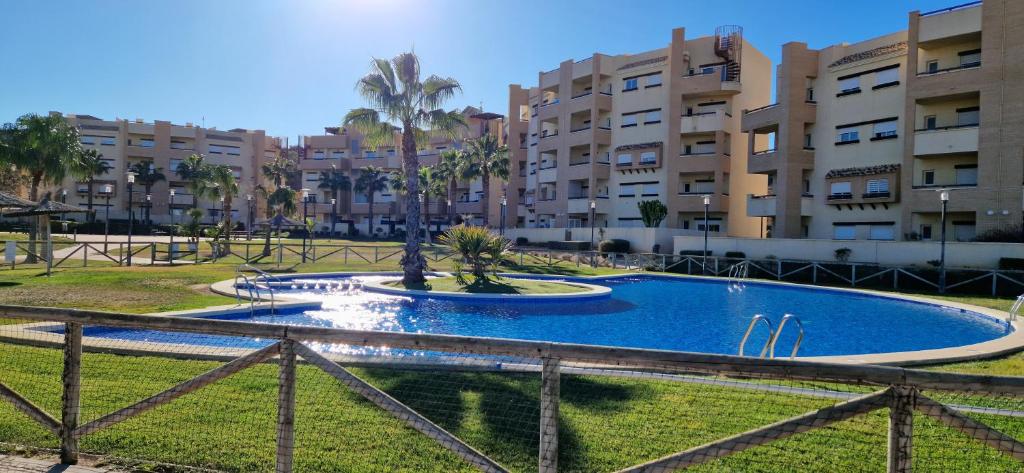 a swimming pool in front of a apartment complex at Tranquila y bonita casa in Murcia