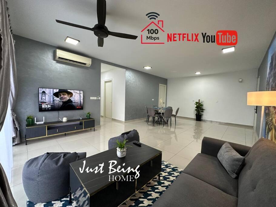 a living room with a couch and a tv at JBH Family Suite for 6pax King/Queen/Single/Sofa in Kuala Lumpur