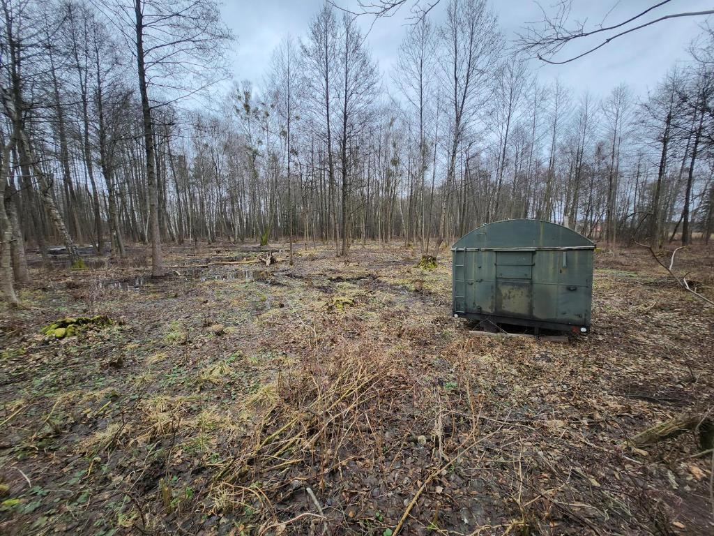 a green box sitting in the middle of a forest at Bushcraft survival nocleg dla samca alfa 