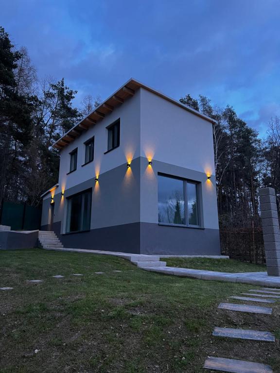 a house with lights on the side of it at The Houses - Chata u sjezdovky 2 in Velké Meziříčí