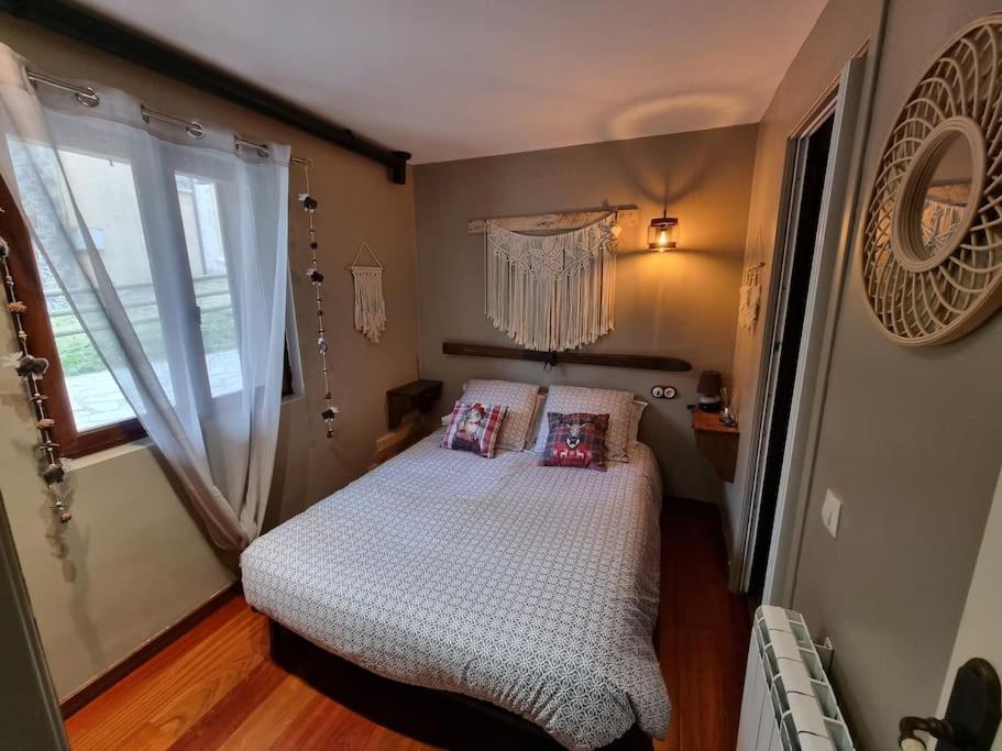 a small bedroom with a bed and a window at petit studio cosy in Saint-Pierre-dels-Forcats