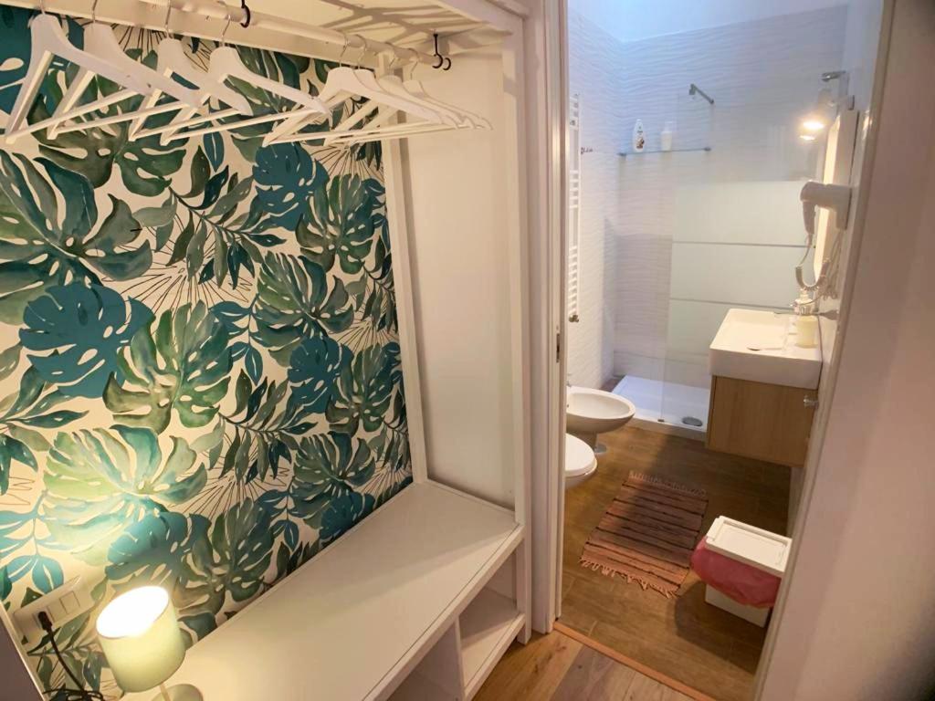 a bathroom with a shower and a toilet and a sink at Talismano Luxury Rooms & Apartments in Naples