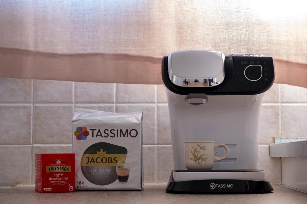 a coffee maker with a phone on top of it at Billy's House in Samos