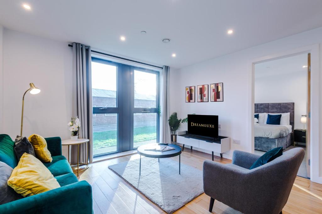 a living room with a couch and chairs and a bed at Sterling Suite - Modern 2 Bedroom Apartment in Birmingham City Centre - Perfect for Family, Business and Leisure Stays by Dreamluxe in Birmingham