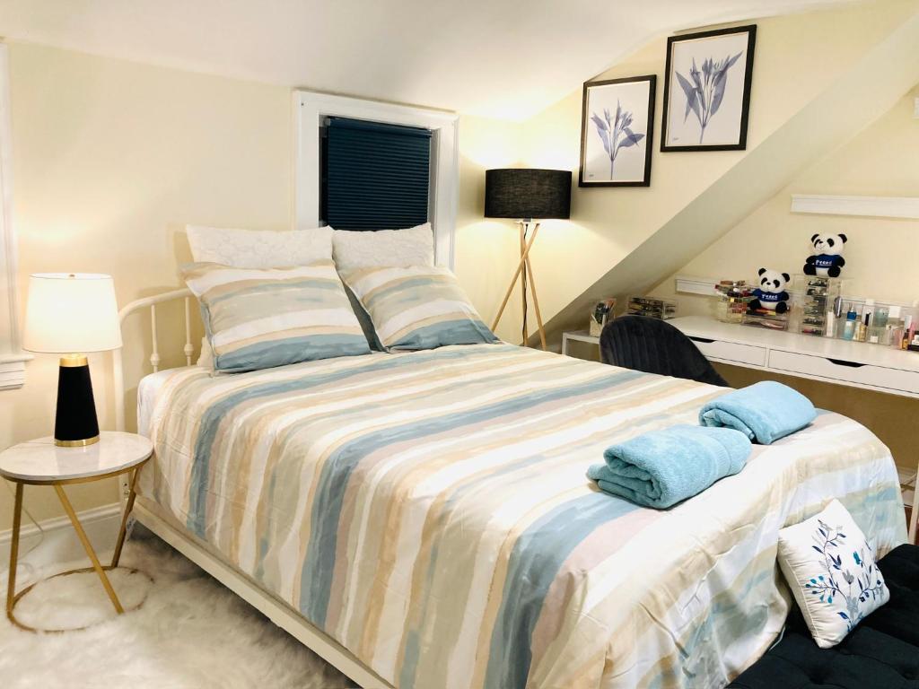 a bedroom with a bed with blue towels on it at Private Bedroom in a Single House at Framingham center in Cranston