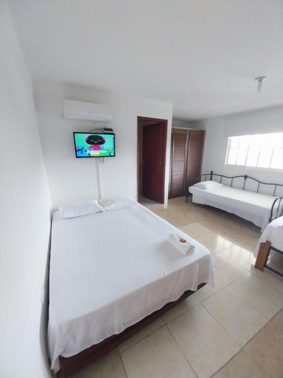 Postel nebo postele na pokoji v ubytování Hotel Sierra Nevada B&B SAS