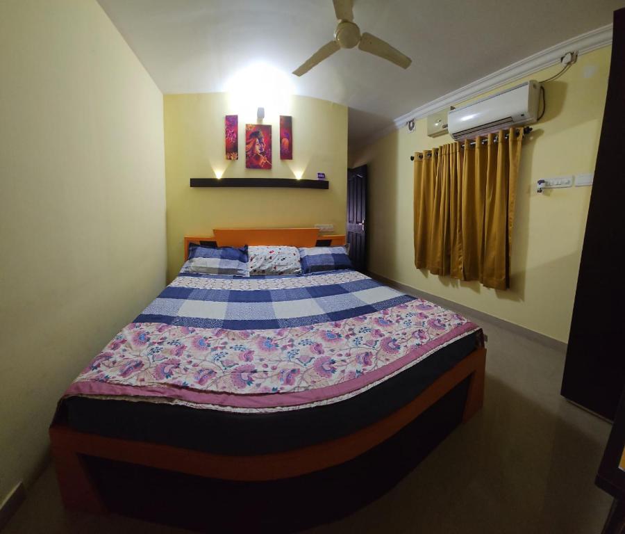 a bedroom with a large bed in a room at Joys Stay in Trichūr