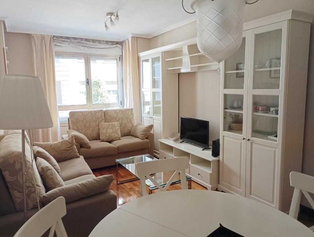 sala de estar con sofá y mesa en Centro-GASCONA con terraza, garaje y wifi gratuito en Oviedo