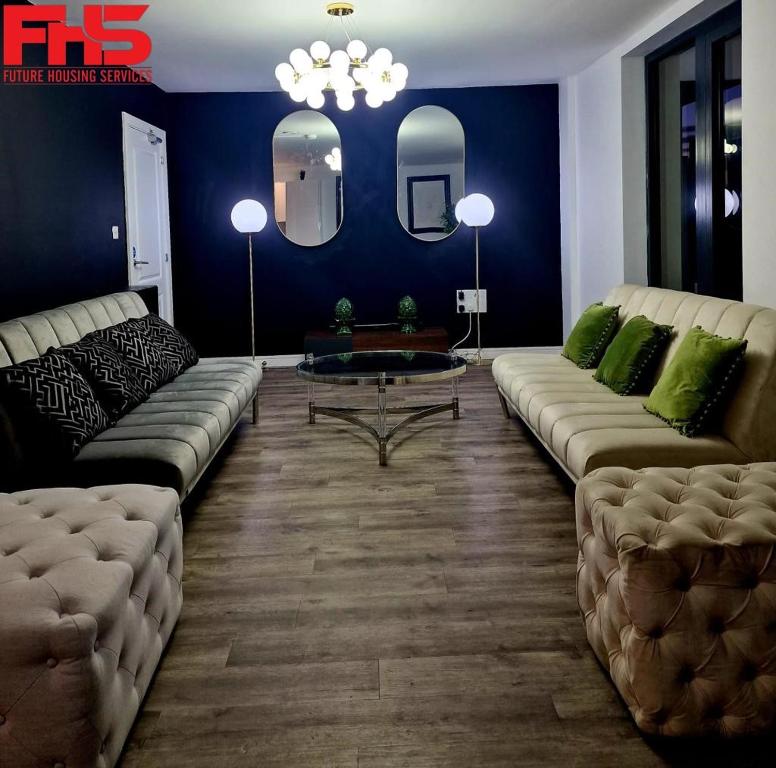 a living room with a couch and a table at Digbeth Luxury Apartment in Birmingham