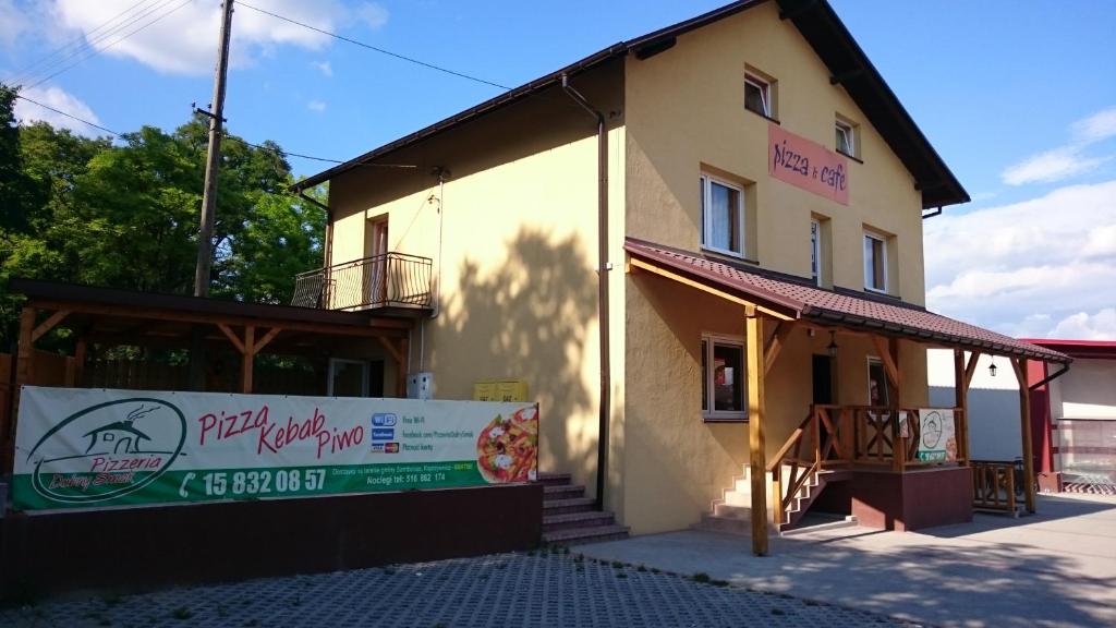 a building with a sign on the side of it at Noclegi Dobry Sen in Samborzec